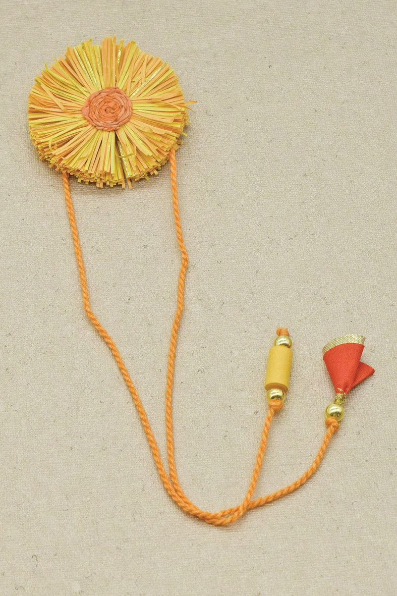 Paper Shred Unicolour Rakhi with Paper Tassels