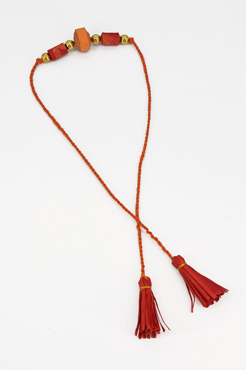 Trimmed paper bead rakhi with tassel