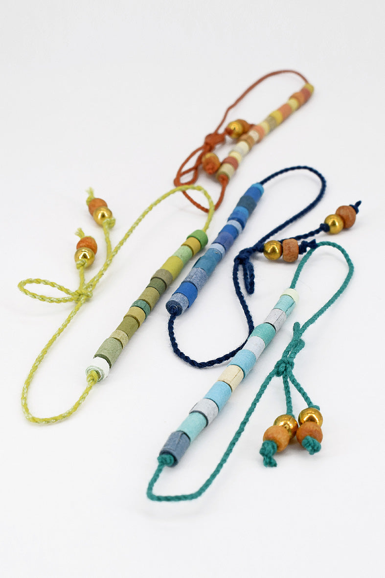 Paper trimmed tonal beads rakhi with tassel