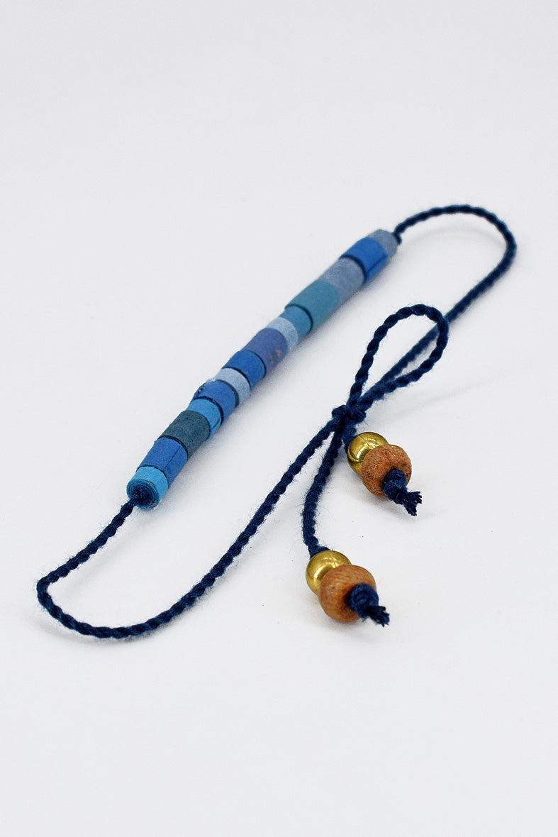 Paper trimmed tonal beads rakhi with tassel