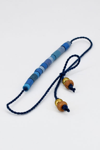 Paper trimmed tonal beads rakhi with tassel