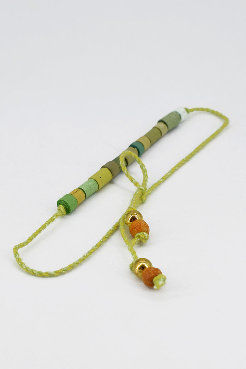 Paper trimmed tonal beads rakhi with tassel