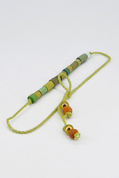 Paper trimmed tonal beads rakhi with tassel