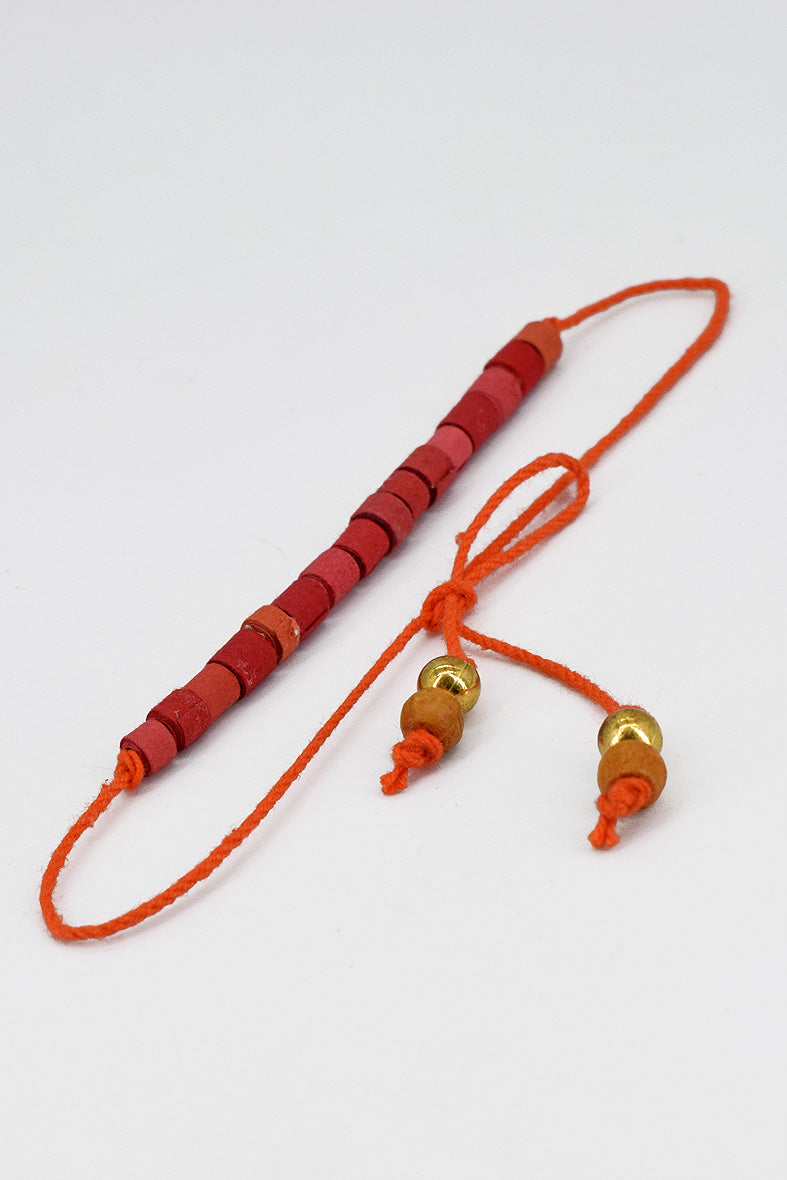 Paper trimmed tonal beads rakhi with tassel