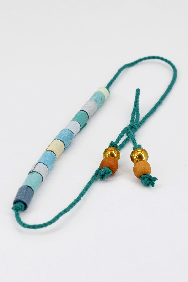 Paper trimmed tonal beads rakhi with tassel