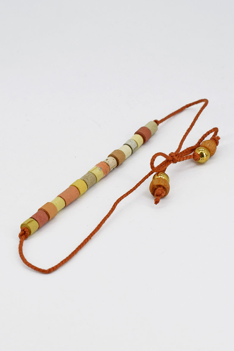 Paper trimmed tonal beads rakhi with tassel