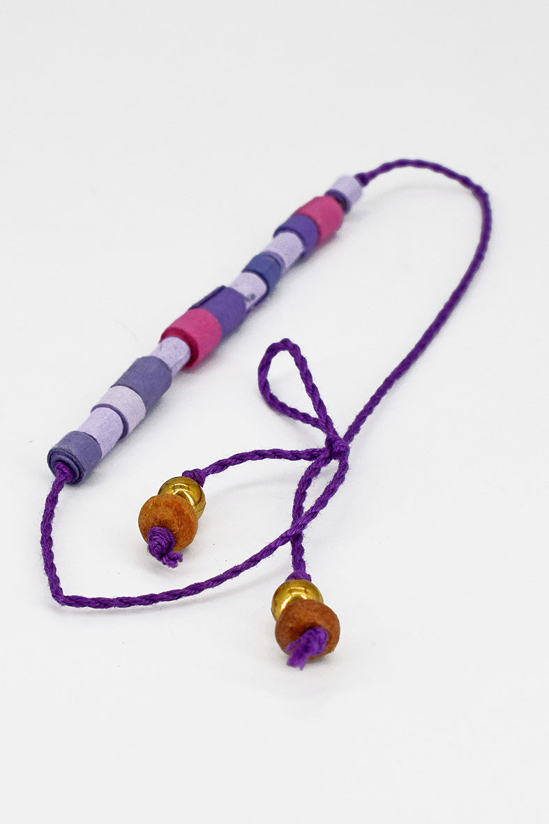 Paper trimmed tonal beads rakhi with tassel