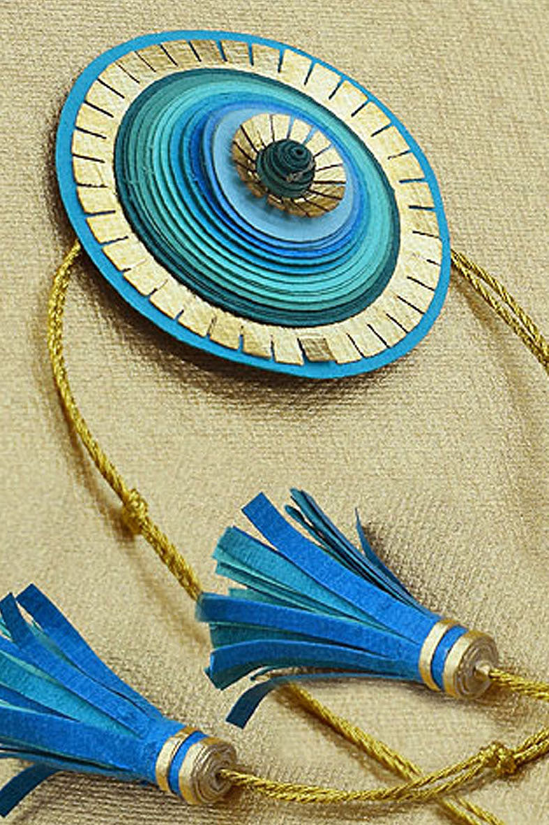Quill & Kavach With Tasseled Ends Paper Rakhi Online